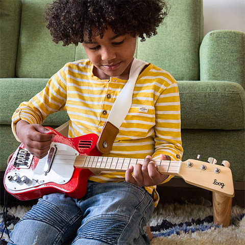 Child playing Loog Guitar