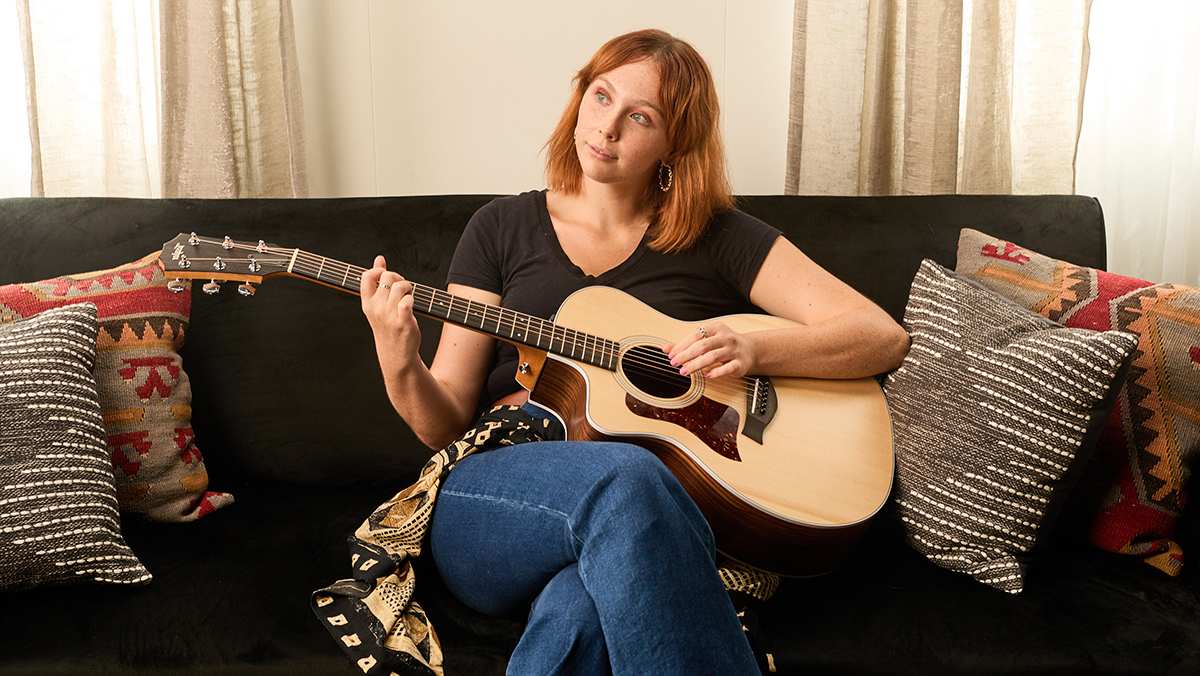 Woman playing 214ce on a couch