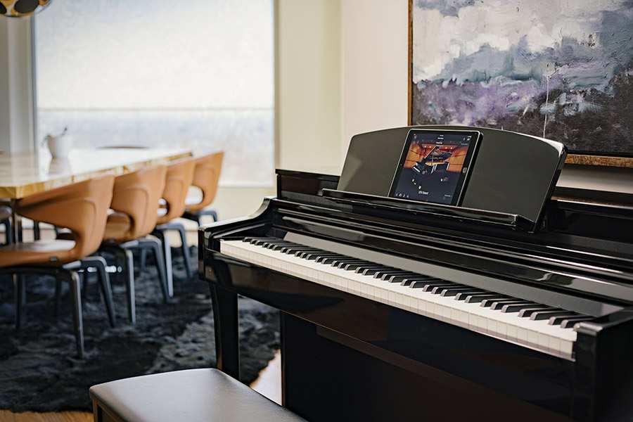 Yamaha CSP Clavinova in casual performance environment with iPad and app showing
