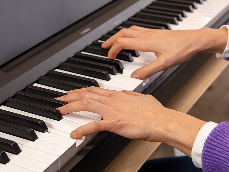 Hands playing a piano