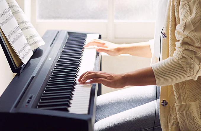 hands playing piano keys