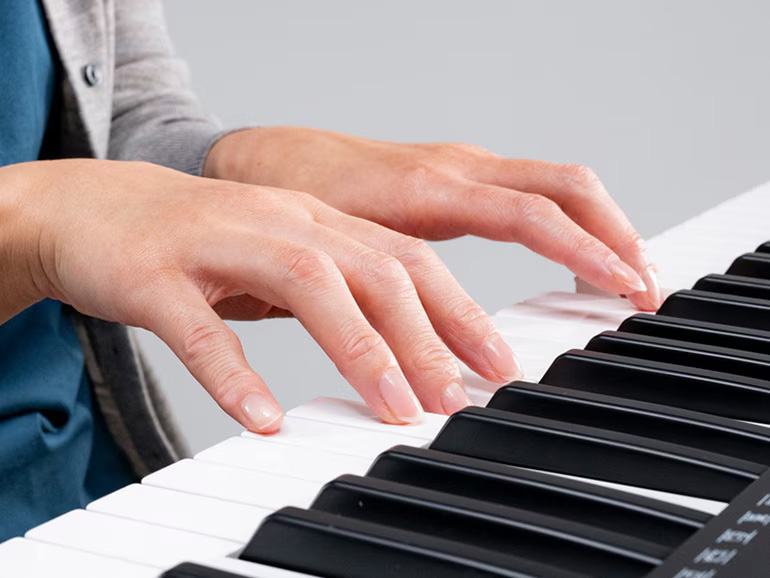 hands playing keyboard close detail