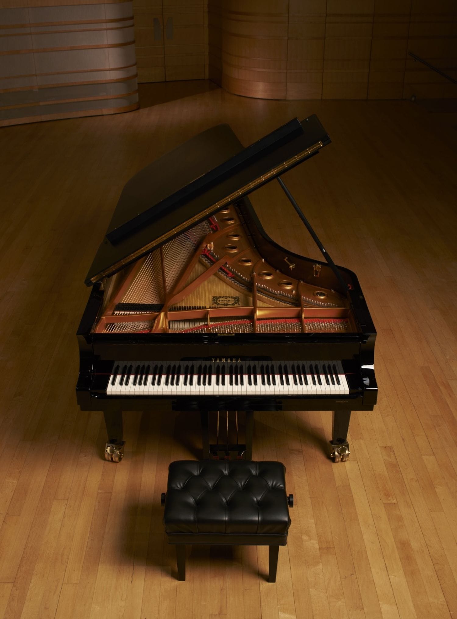 Top-down view of a Yamaha CF Piano on an empty stage.