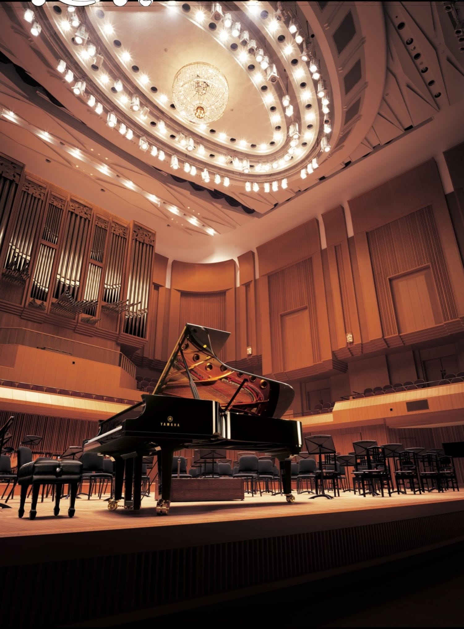 View of a Yamaha CF Piano on a stage in front of orchestral seating.